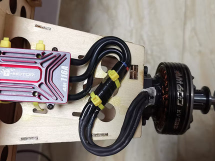 Electrical components with wires on a wooden board against a neutral background