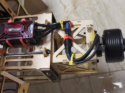 Mechanical setup with a red and black component on a tiled floor