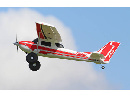 Small airplane with red and white design flying against a blue sky.