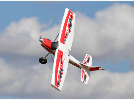 Model airplane flying against a cloudy sky
