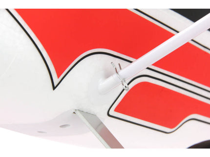 Close-up of a red and white logo with black accents on a white background