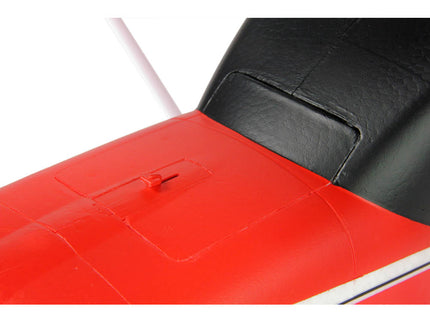 Close-up of a red and black motorcycle seat on a white background