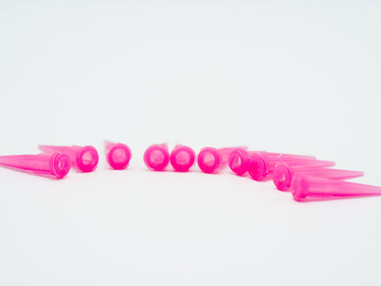 Row of pink plastic cones on a white background