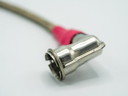 Close-up of a metal connector with a pink cable on a white background