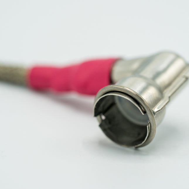 Metallic garden hose nozzle with pink rubber on a white background