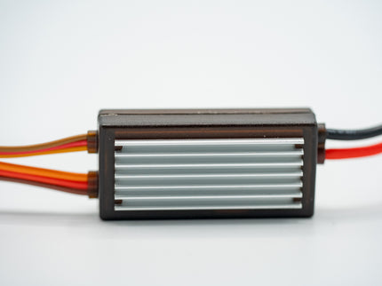 Rectangular electronic component with cooling fins and wires on a white background