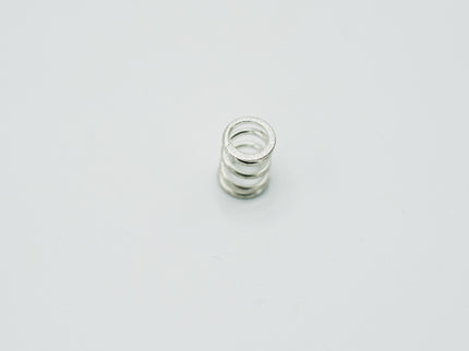 Silver spiral spring on a light gray background
