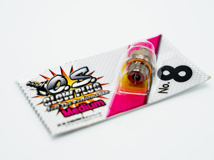 Vial of pink liquid with a labeled packaging on a white background
