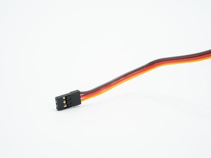 Black electronic component with red and black wires on a white background