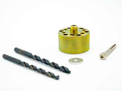 Set of drill bits and a metal cylindrical tool on a white background