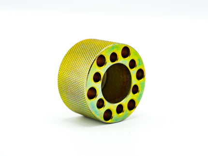 Green spool of thread on a white background