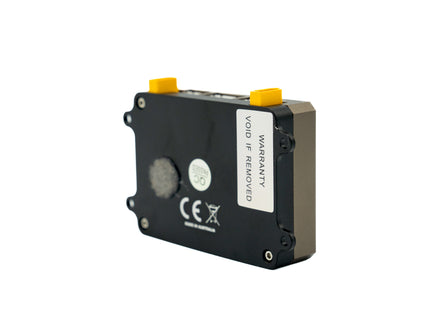 Black electronic module with yellow connectors on a white background