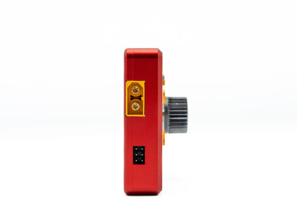 Red electronic device with a yellow connector and black switch on a white background