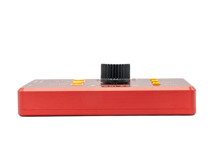 Red electronic device with a black knob on a white background