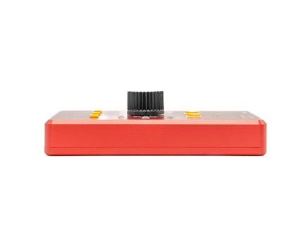 Red electronic device with a black knob on a white background
