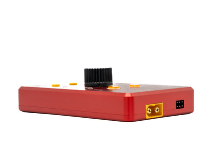 Red electronic device with a black top component on a white background