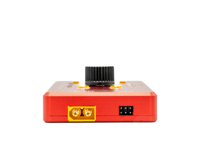 Red electronic device with black top and yellow label on a white background