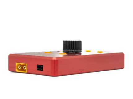 Red electronic device with a black knob on a white background