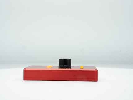 Red electronic device with a black component on a white background