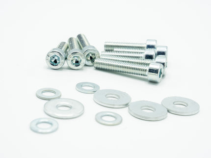 Set of metal screws and washers on a white background