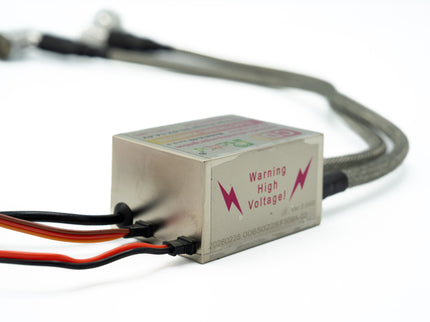 Electronic component with wires and 'Warning High Voltage!' label on a white background