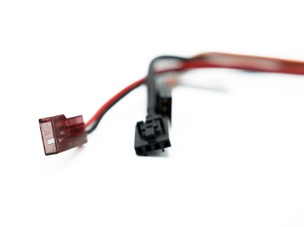 Two electrical connectors with red and black wires on a white background
