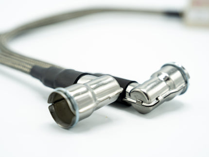 Close-up of a metal cable with connectors on a white background