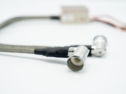 Close-up of a metal cable with connectors on a white background