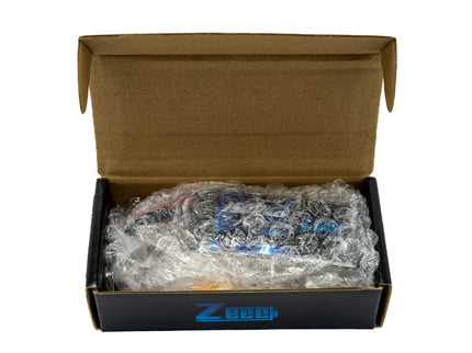 Open cardboard box with bubble wrap containing a Zeee product on a white background