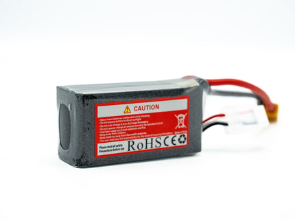 Battery pack with warning label and red and yellow cables on a white background