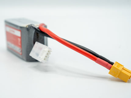 Battery pack with red and black cables and a yellow connector on a white background