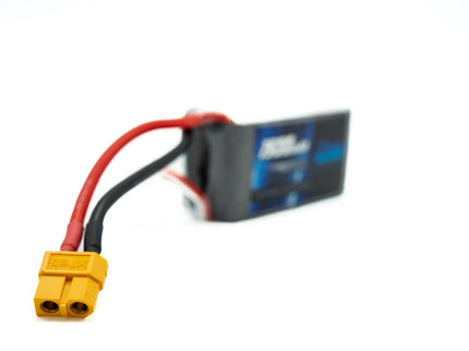 Battery with red and black cables and yellow connector on a white background