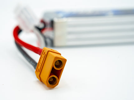 Yellow electrical connector with red and black wires on a white background