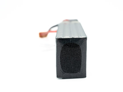 Rectangular black battery with red connector on a white background