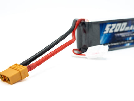 Battery pack with yellow connector and red and black cables on a white background