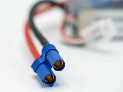Close-up of a blue electrical connector with wires on a blurred background