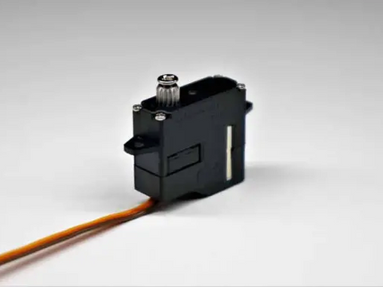 Black servo motor with a cable on a gray background
