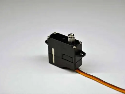 Black servo motor with a wire on a white background