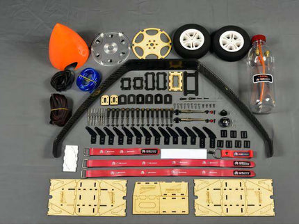 Collection of model building parts and tools on a gray surface