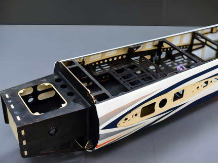 Model train car body with detailed interior on a gray surface