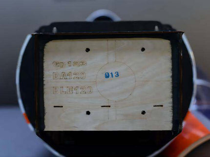 Wooden block with engraved numbers and letters on a blurred background