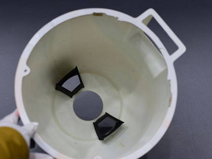 COWL with black and gray components on a dark background