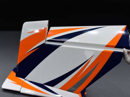 stab and elevator with orange, white, and blue design held by a hand on a dark background
