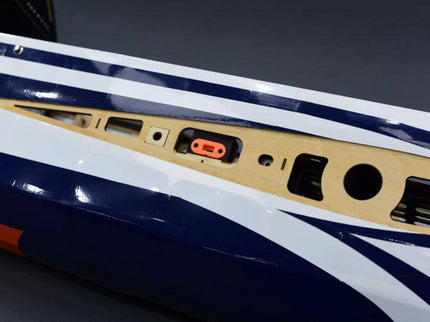 Close-up of a fuselage side panel with various ports and switches on a dark background
