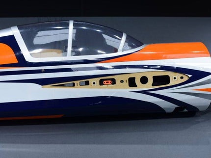 Close-up of a model airplane with orange, white, and blue design on a gray background