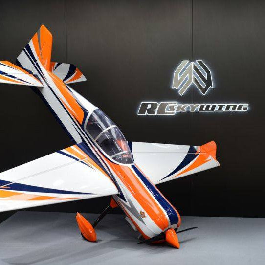 Model airplane with orange and white design against a dark background featuring a logo.