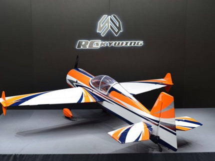 Model airplane with orange and white design on a gray surface against a black background with a logo.