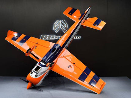 Orange RC airplane on a gray surface with a dark background