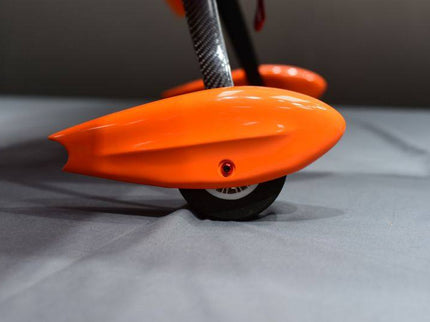 Close-up of an orange wheel pants with a dark background