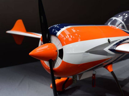 Model airplane with orange and white design on a dark background